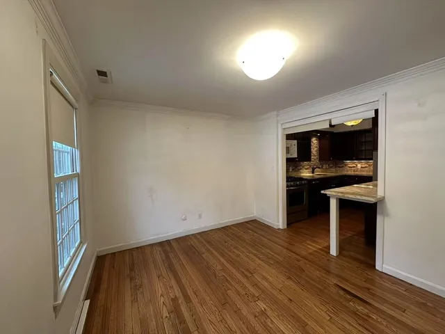 a view of kitchen and dining room with wooden floor