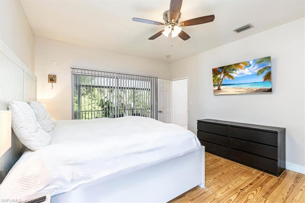 3618 Cottage Club Lane Naples, FL 34105 - Photo 12 of 26 a bed sitting in a bedroom next to a window