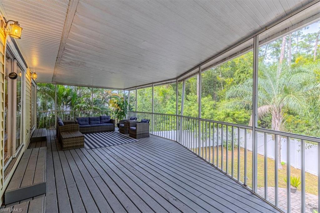 3618 Cottage Club Lane Naples, FL 34105 - Photo 21 of 26 a view of a chairs and table on the wooden deck