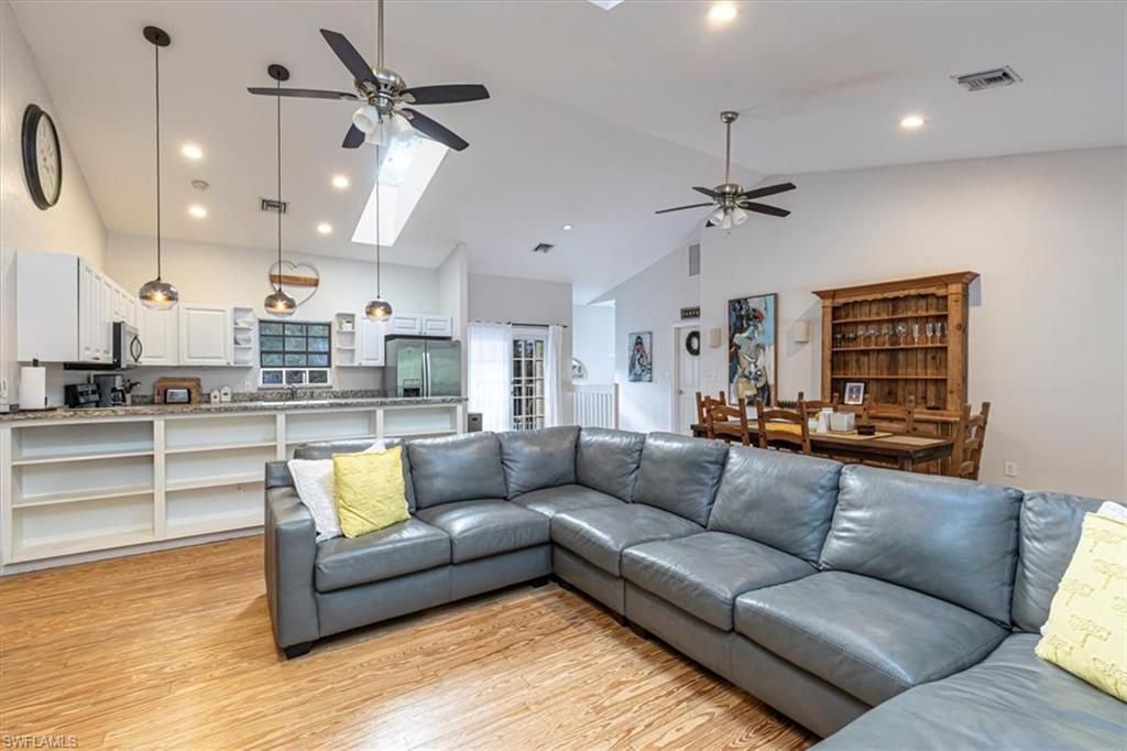 3618 Cottage Club Lane Naples, FL 34105 - Photo 3 of 26 a living room with furniture and kitchen view
