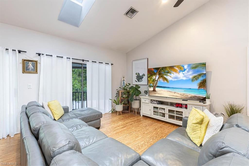 3618 Cottage Club Lane Naples, FL 34105 - Photo 8 of 26 a living room with furniture and a flat screen tv