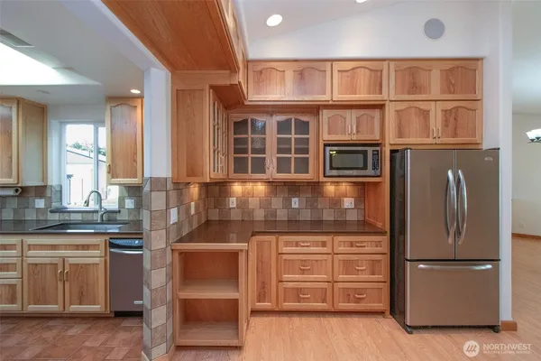 a kitchen with cabinets and stainless steel appliances