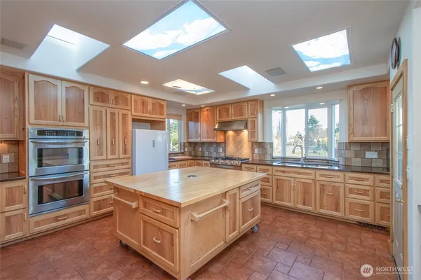 a kitchen with stainless steel appliances granite countertop a stove and a refrigerator