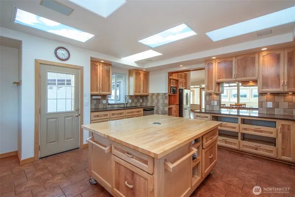 a kitchen with a stove a sink and a refrigerator