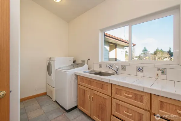 a utility room with a sink washer and dryer
