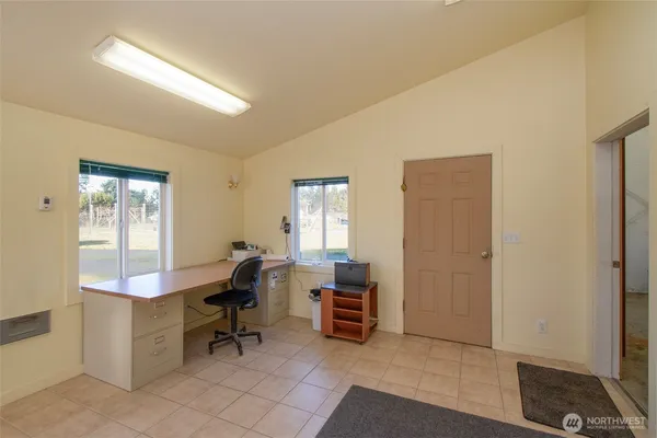 a view of a workspace with furniture and windows