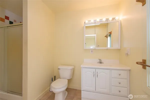 a bathroom with a toilet sink and mirror