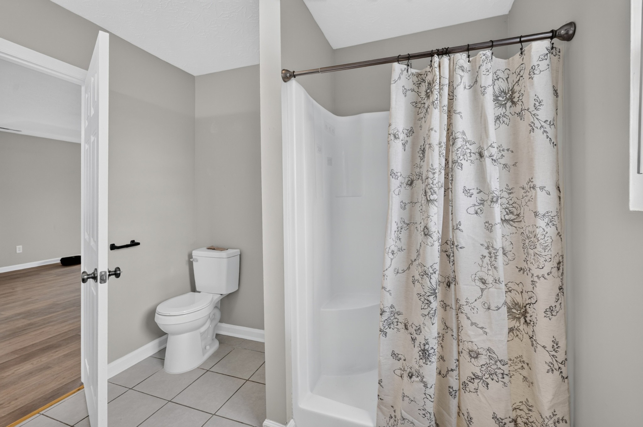 120 Driver Road Lafayette, TN 37083 - Photo 23 of 39 a white toilet sitting next to a shower curtain