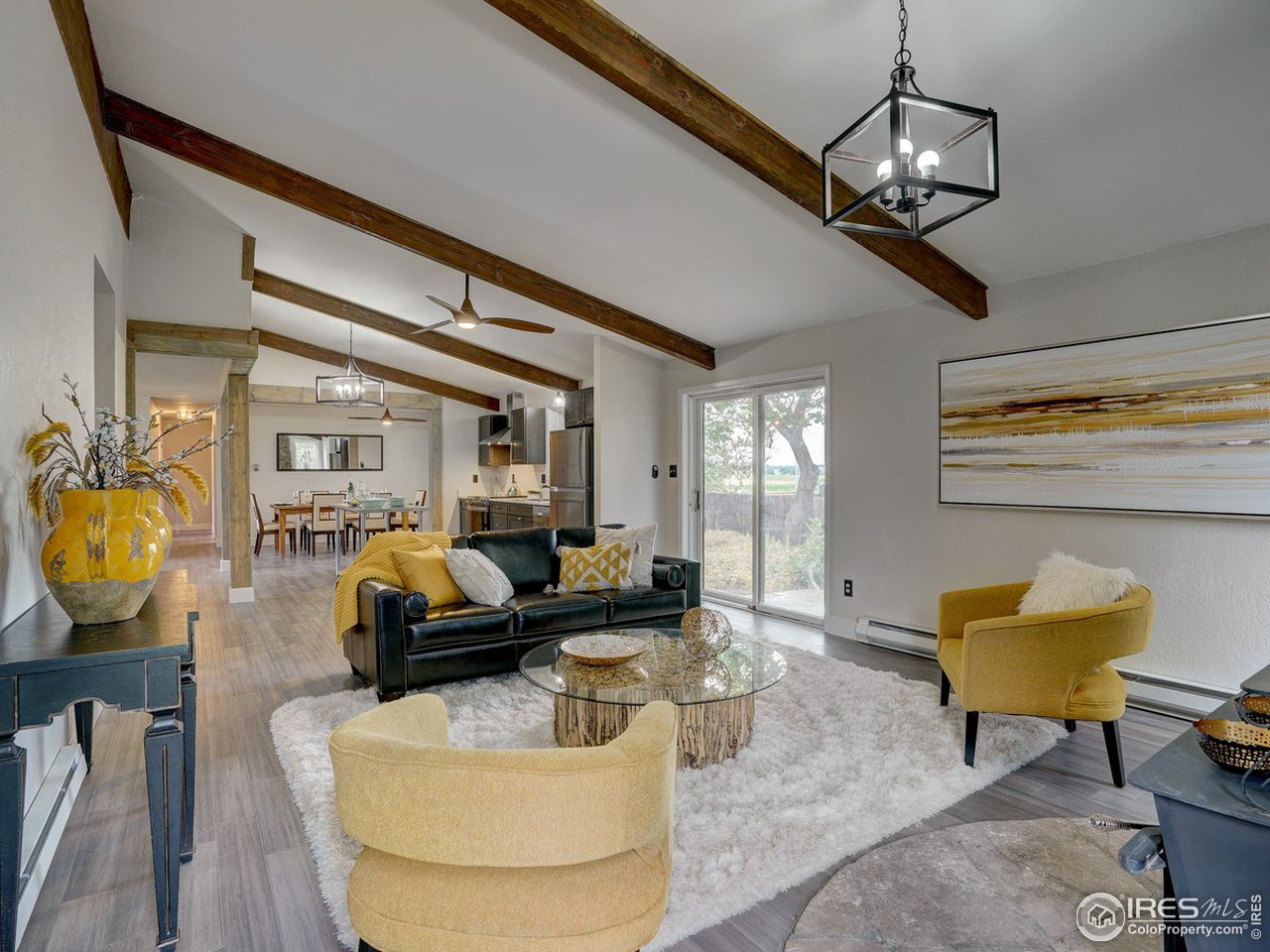 7823 Hygiene Road Longmont, CO 80503 - Photo 11 of 21 a living room with furniture and a chandelier