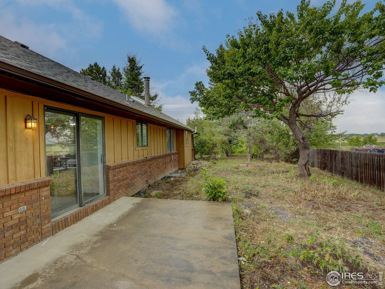 7823 Hygiene Road Longmont, CO 80503 - Photo 18 of 21 a backyard of a house with plants and trees