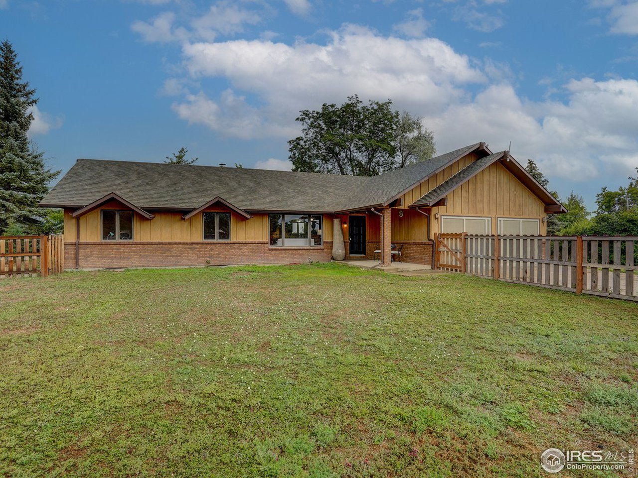 7823 Hygiene Road Longmont, CO 80503 - Photo 2 of 21 a front view of a house with garden