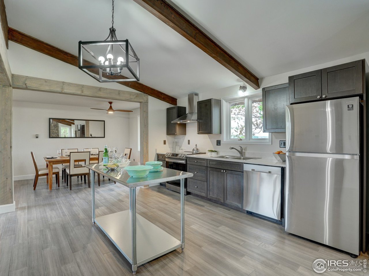 7823 Hygiene Road Longmont, CO 80503 - Photo 7 of 21 a kitchen with stainless steel appliances granite countertop a stove refrigerator dining table and chairs