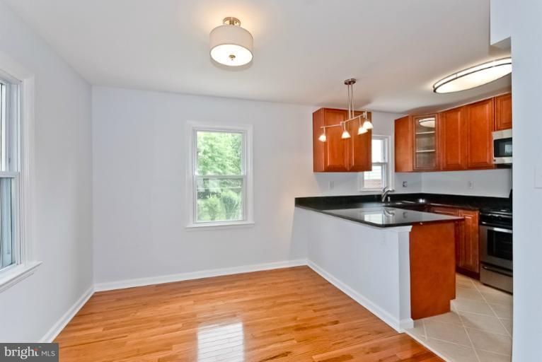 6600 Riggs Road Hyattsville, MD 20783 - Photo 1 of 24 a kitchen with granite countertop a stove and a sink