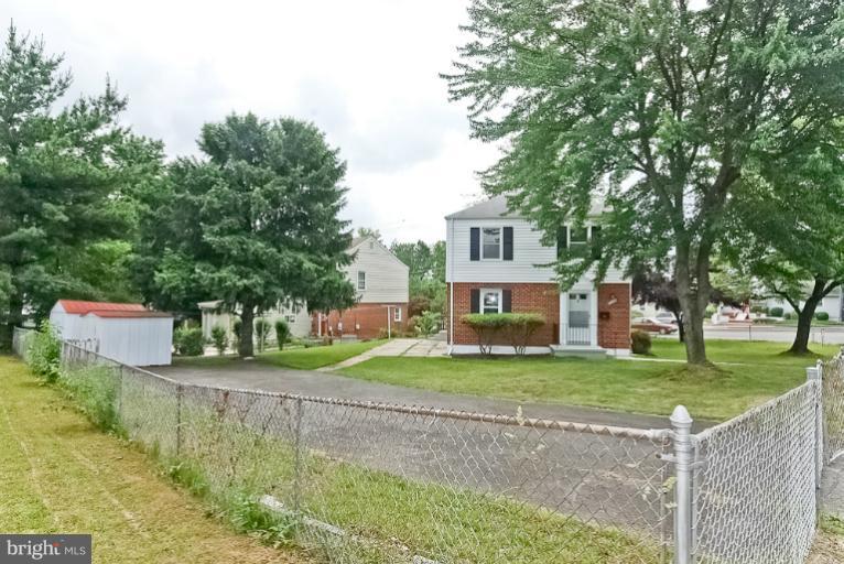 6600 Riggs Road Hyattsville, MD 20783 - Photo 13 of 24 a view of a house with a yard and large trees