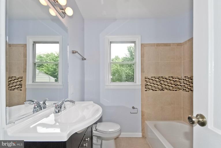 6600 Riggs Road Hyattsville, MD 20783 - Photo 16 of 24 a bathroom with a sink toilet and shower