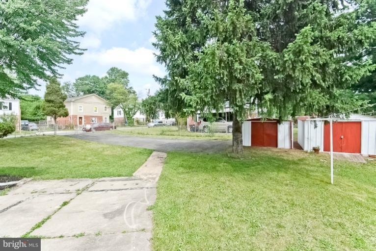 6600 Riggs Road Hyattsville, MD 20783 - Photo 6 of 24 a backyard of a house with barbeque oven and outdoor seating