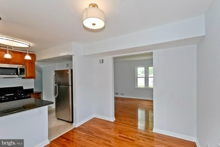 6600 Riggs Road Hyattsville, MD 20783 - Photo 9 of 24 a kitchen with a refrigerator and a stove top oven
