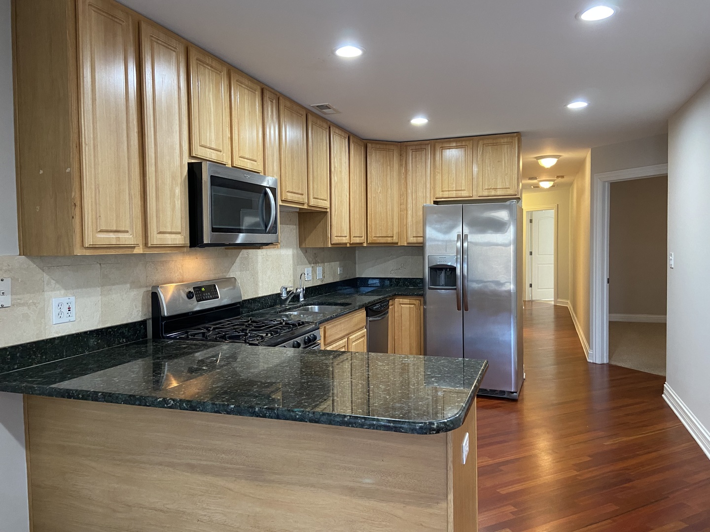 2525 West Harrison Street, Unit 2 Chicago, IL 60612 - Photo 4 of 16 a kitchen with stainless steel appliances granite countertop a sink a stove and a granite counter top