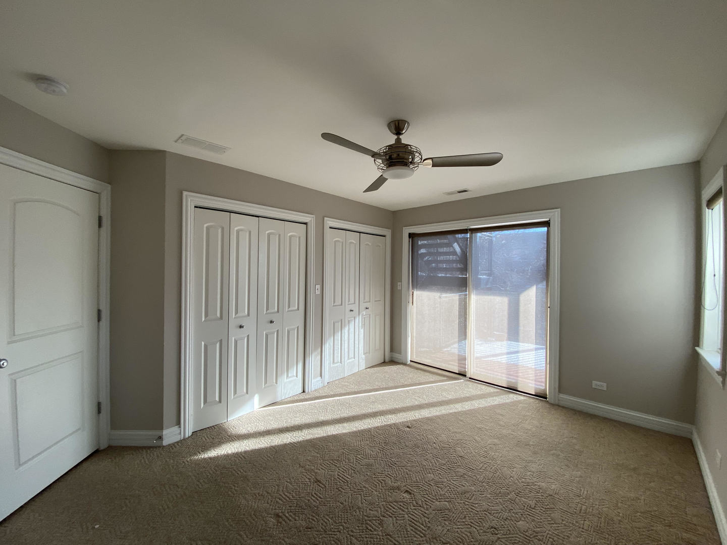 2525 West Harrison Street, Unit 2 Chicago, IL 60612 - Photo 6 of 16 a view of a livingroom with a ceiling fan and windows