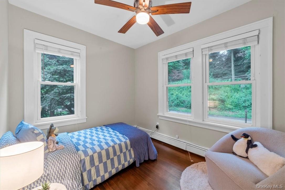 28 Inningwood Road Ossining, NY 10562 - Photo 28 of 37 Bedroom with ceiling fan, multiple windows, dark hardwood / wood-style floors, and baseboard heating