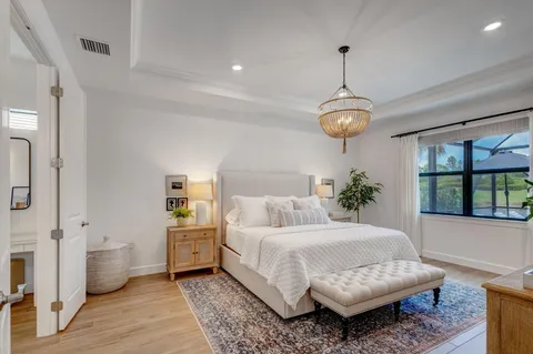 a living room with a balcony furniture and a chandelier