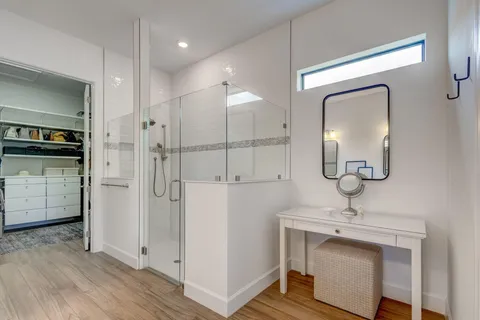 a bathroom with a sink a mirror and shower
