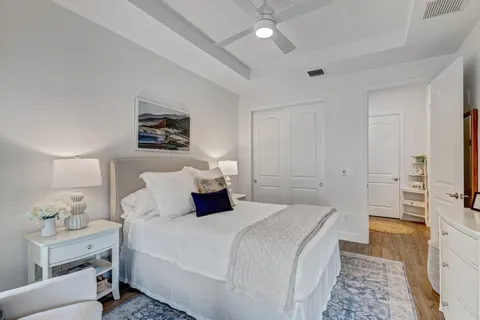 a bedroom with a bed and a flat tv screen on dresser