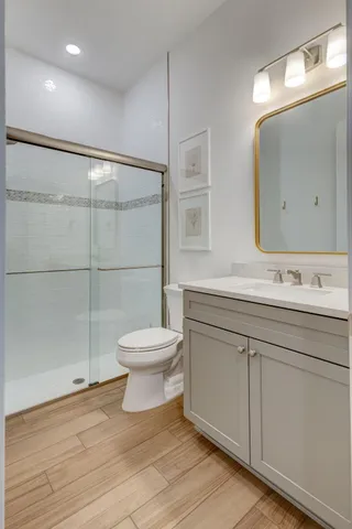 a bathroom with a toilet a sink and mirror