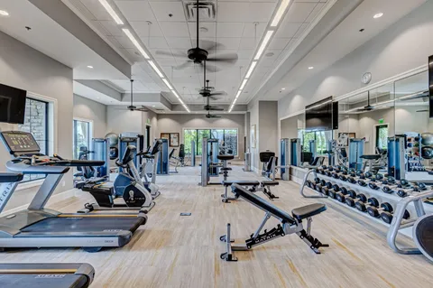 a kitchen with granite countertop a refrigerator and a sink