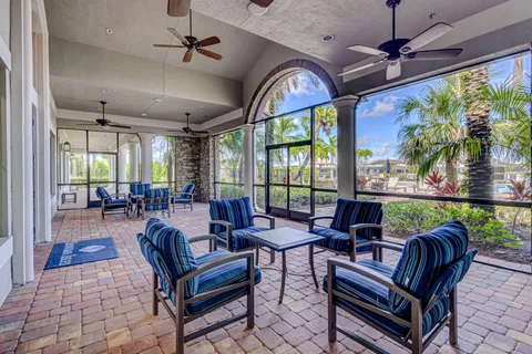 a view of a house with a yard and sitting area