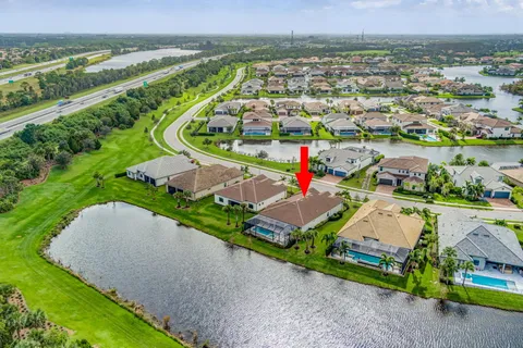 an aerial view of a house with a garden and lake view