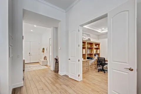 a view of a workspace with wooden floor and a bathroom