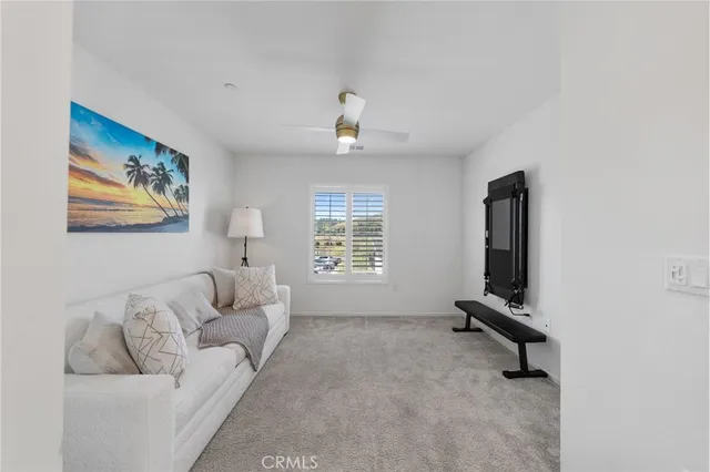 a living room with furniture and a lamp
