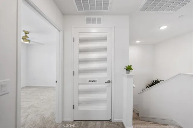 a view of a workspace with furniture and a fan