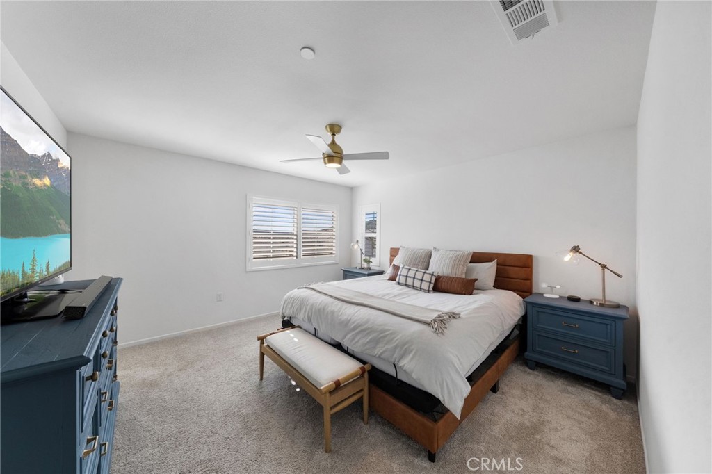 303 Sweet Place Fallbrook, CA 92028 - Photo 24 of 59 a bedroom with a bed and a flat screen tv