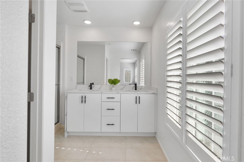 303 Sweet Place Fallbrook, CA 92028 - Photo 27 of 59 a bathroom with a double vanity sink and mirror