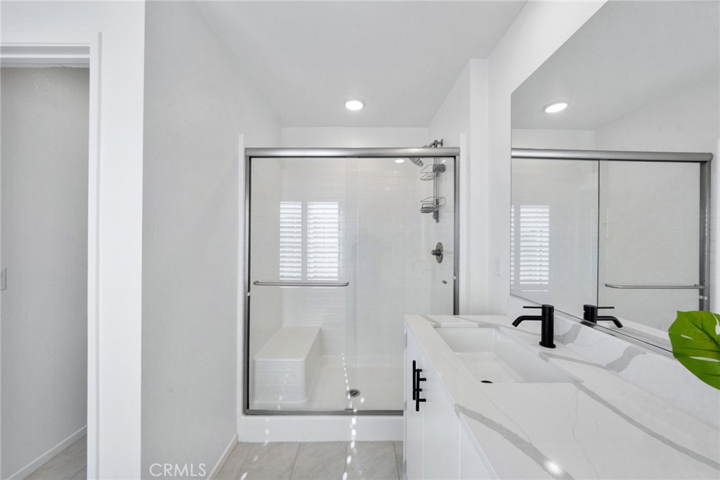 303 Sweet Place Fallbrook, CA 92028 - Photo 28 of 59 a bathroom with a bathtub sink a mirror and shower