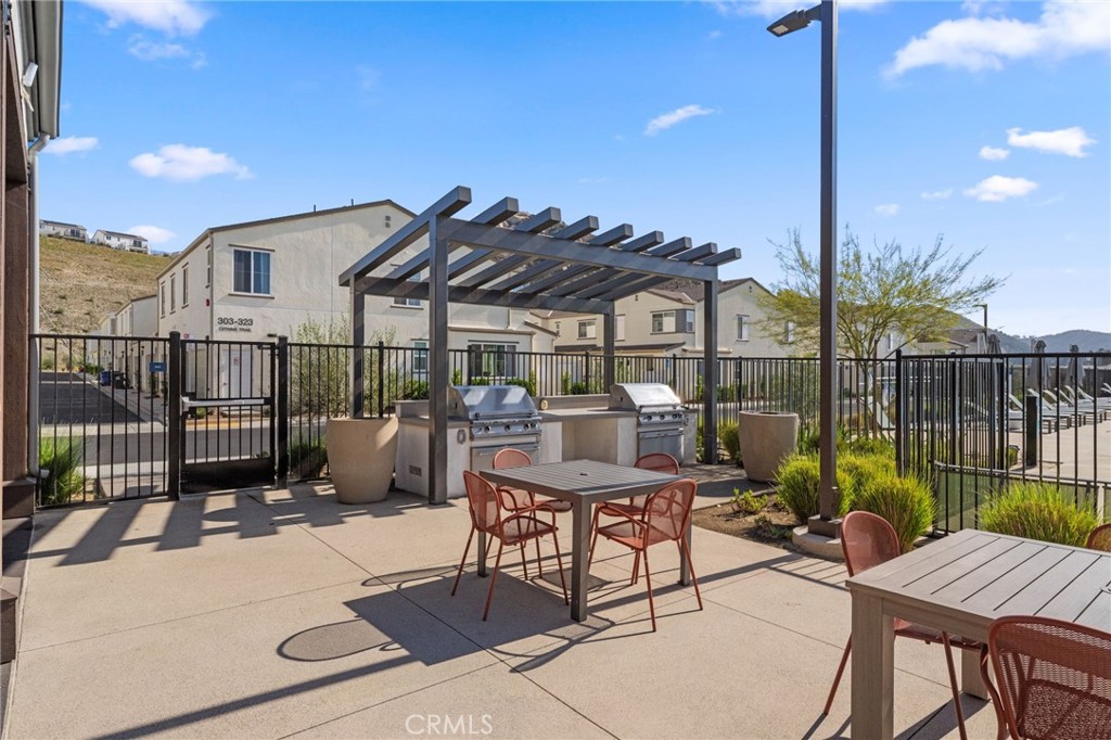 303 Sweet Place Fallbrook, CA 92028 - Photo 44 of 59 a view of a patio with a table and chairs