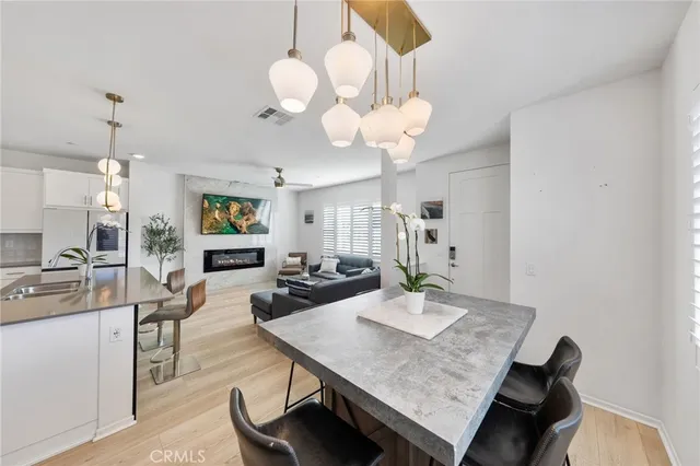 a kitchen with sink stove and wooden floor