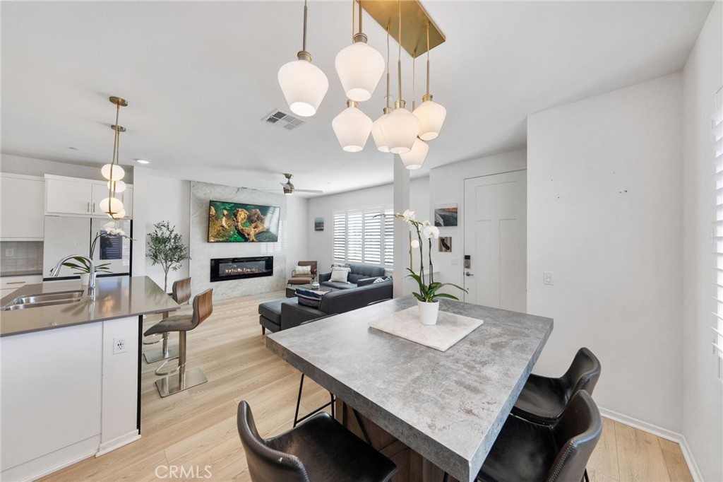 303 Sweet Place Fallbrook, CA 92028 - Photo 8 of 59 a view of a dining room with furniture and wooden floor
