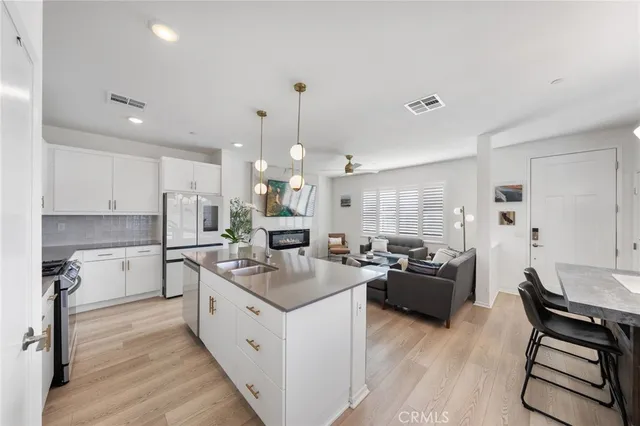 a living room with furniture kitchen and a table