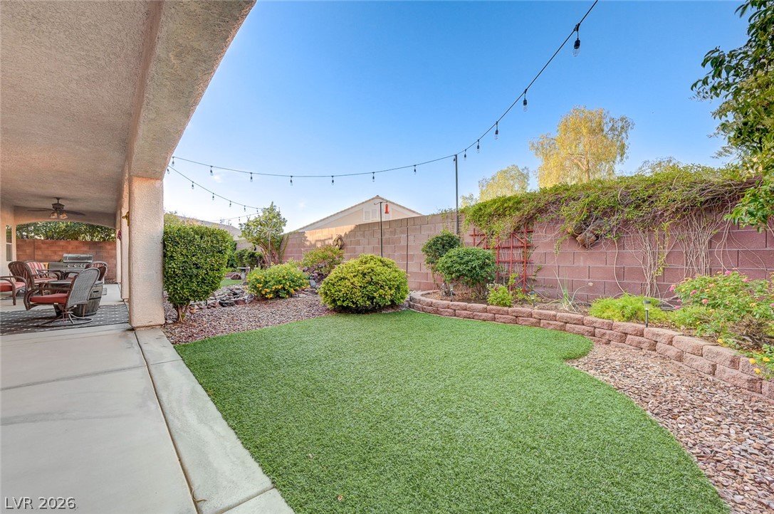 1604 Cattle Ranch Place Henderson, NV 89002 - Photo 73 of 99 A private yard with artificial turf offers an inviting space for relaxation and entertaining.