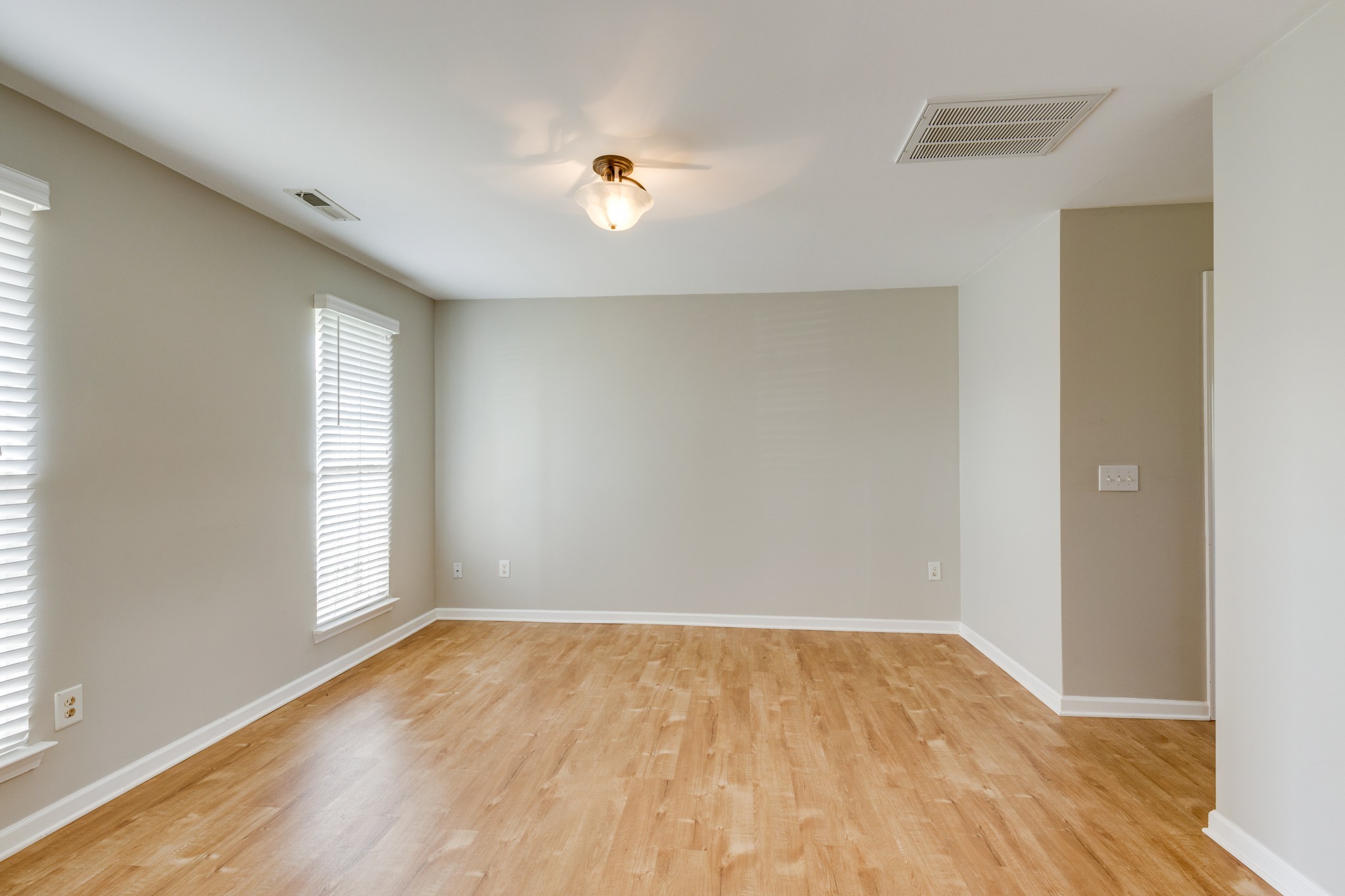 4017 Cadence Drive Spring Hill, TN 37174 - Photo 4 of 38 an empty room with wooden floor and windows
