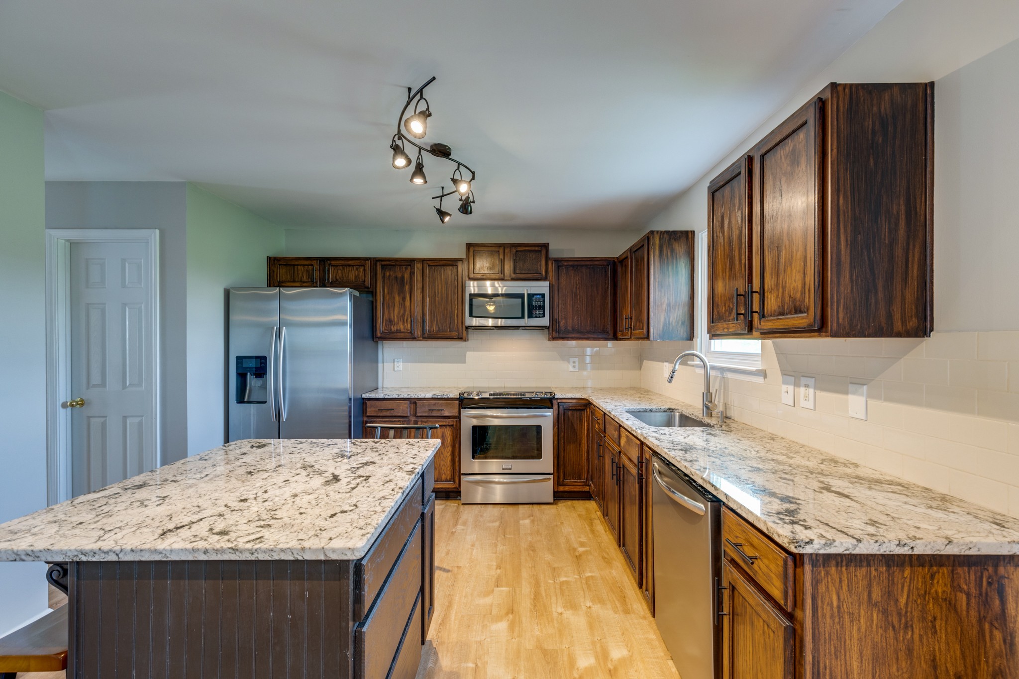 4017 Cadence Drive Spring Hill, TN 37174 - Photo 5 of 38 a kitchen with a stove and a refrigerator