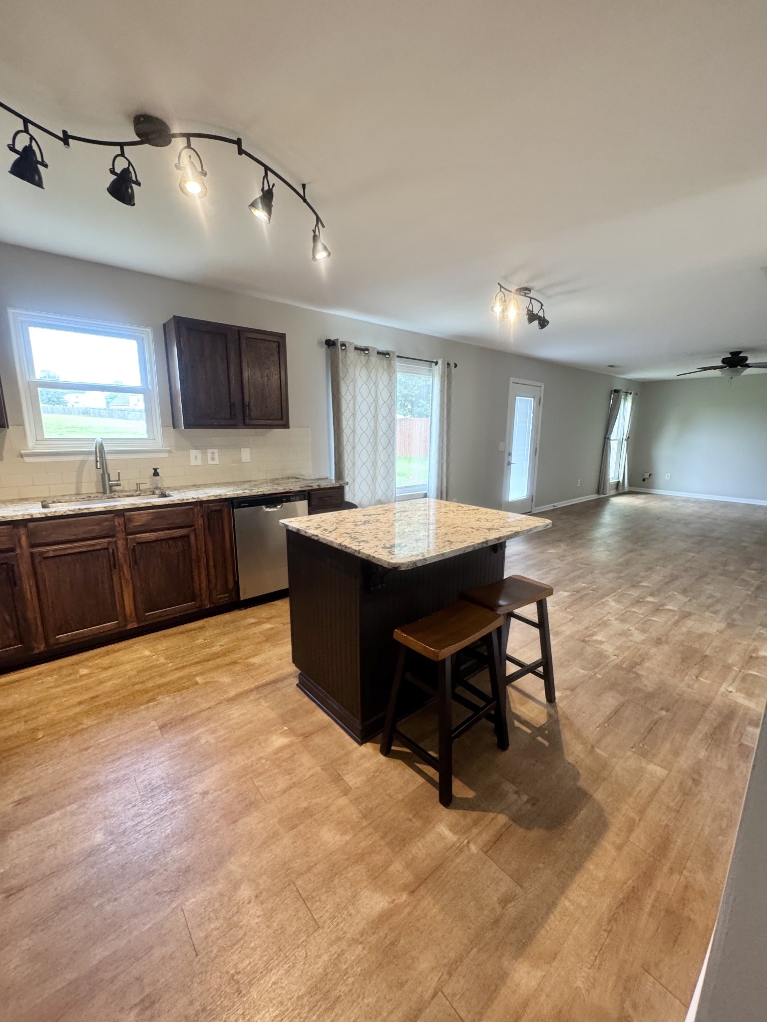 4017 Cadence Drive Spring Hill, TN 37174 - Photo 10 of 38 a large kitchen with kitchen island a sink table and chairs