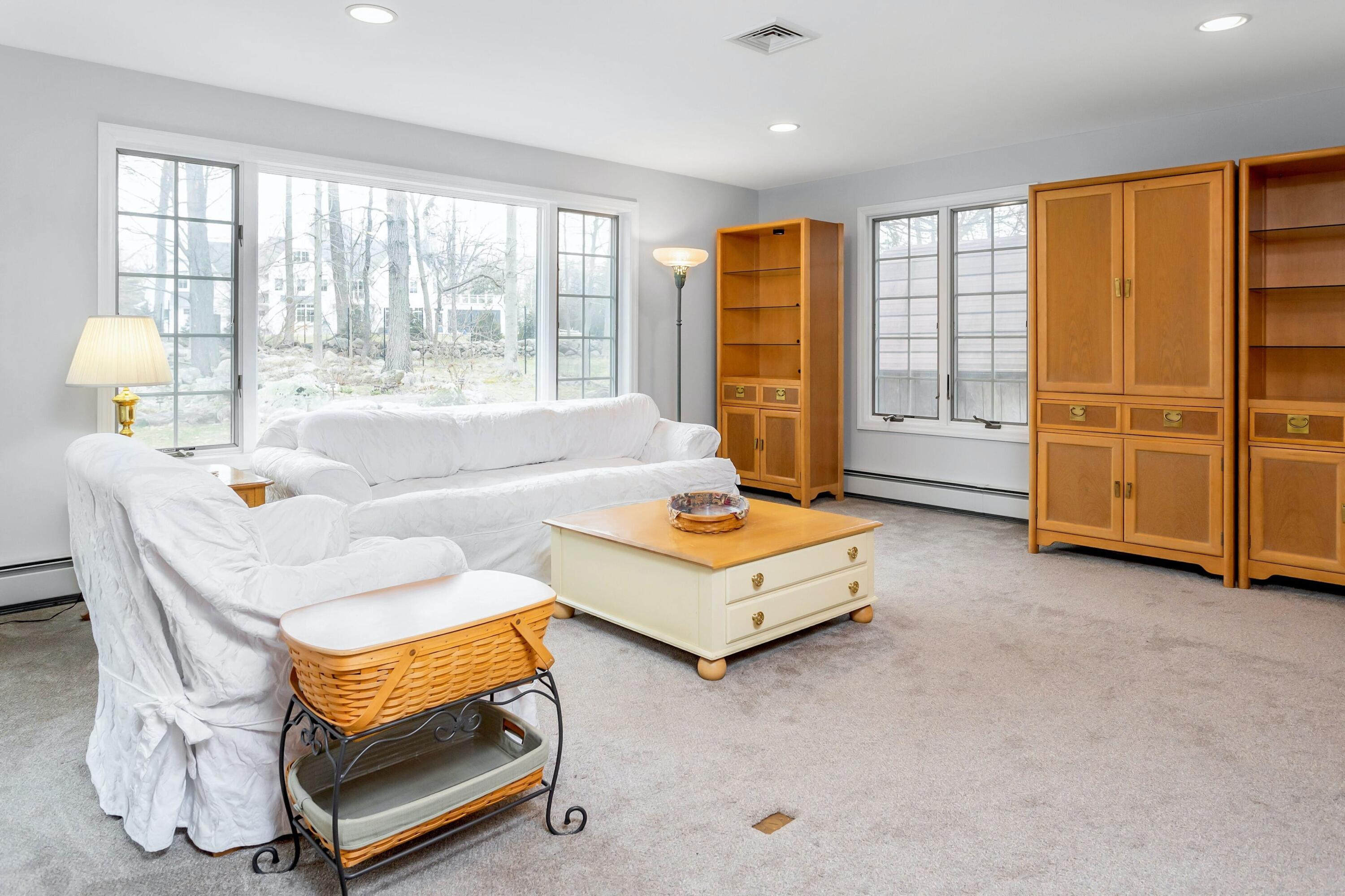 21 Revere Road Darien, CT 06820 - Photo 15 of 40 a living room with furniture a flat screen tv and a window