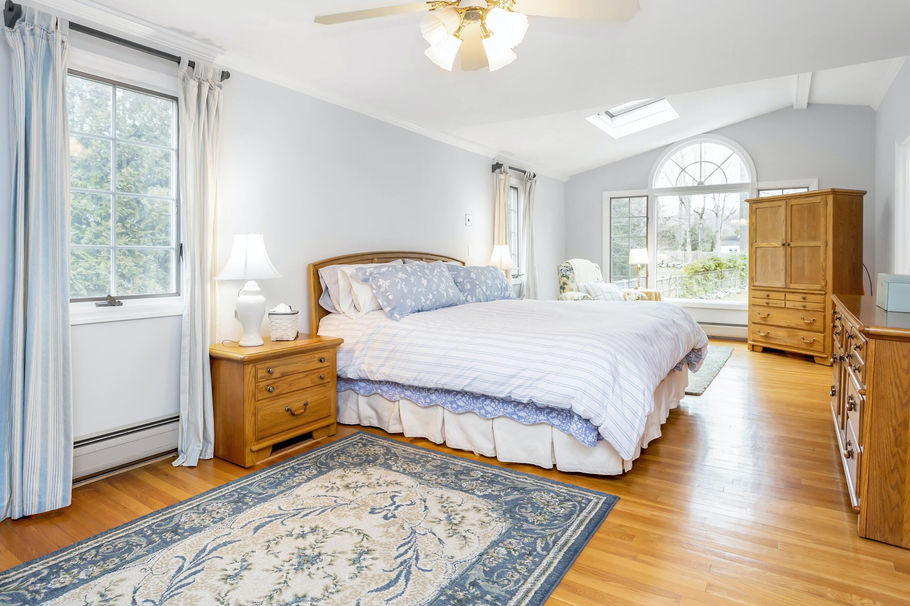 21 Revere Road Darien, CT 06820 - Photo 21 of 40 a bedroom with a bed and wooden floor