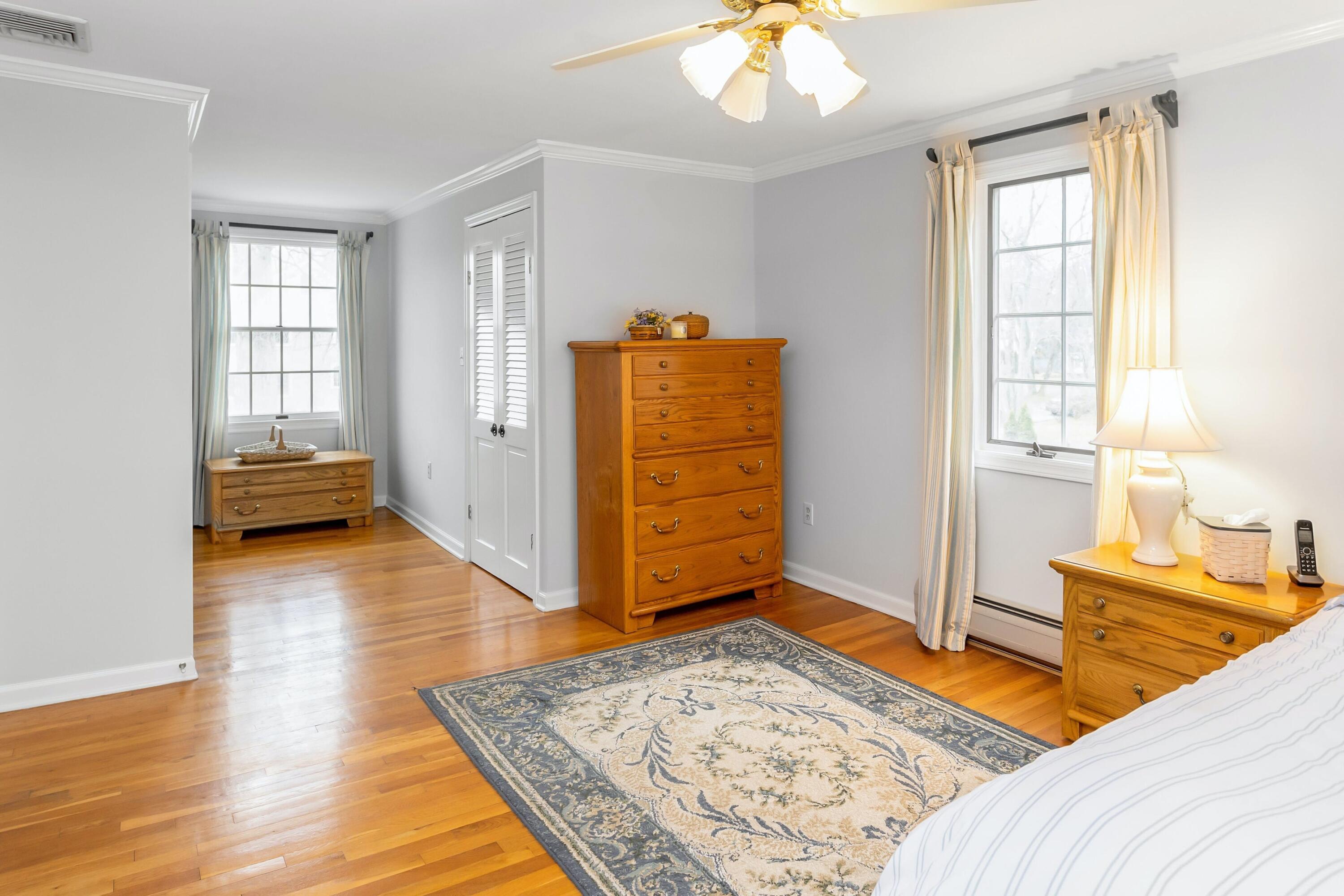 21 Revere Road Darien, CT 06820 - Photo 23 of 40 a bedroom with a bed and wooden floor