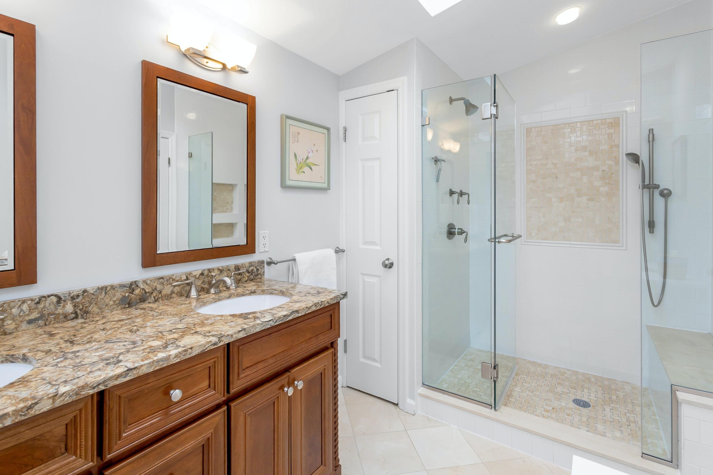 21 Revere Road Darien, CT 06820 - Photo 25 of 40 a bathroom with a granite countertop sink mirror and shower