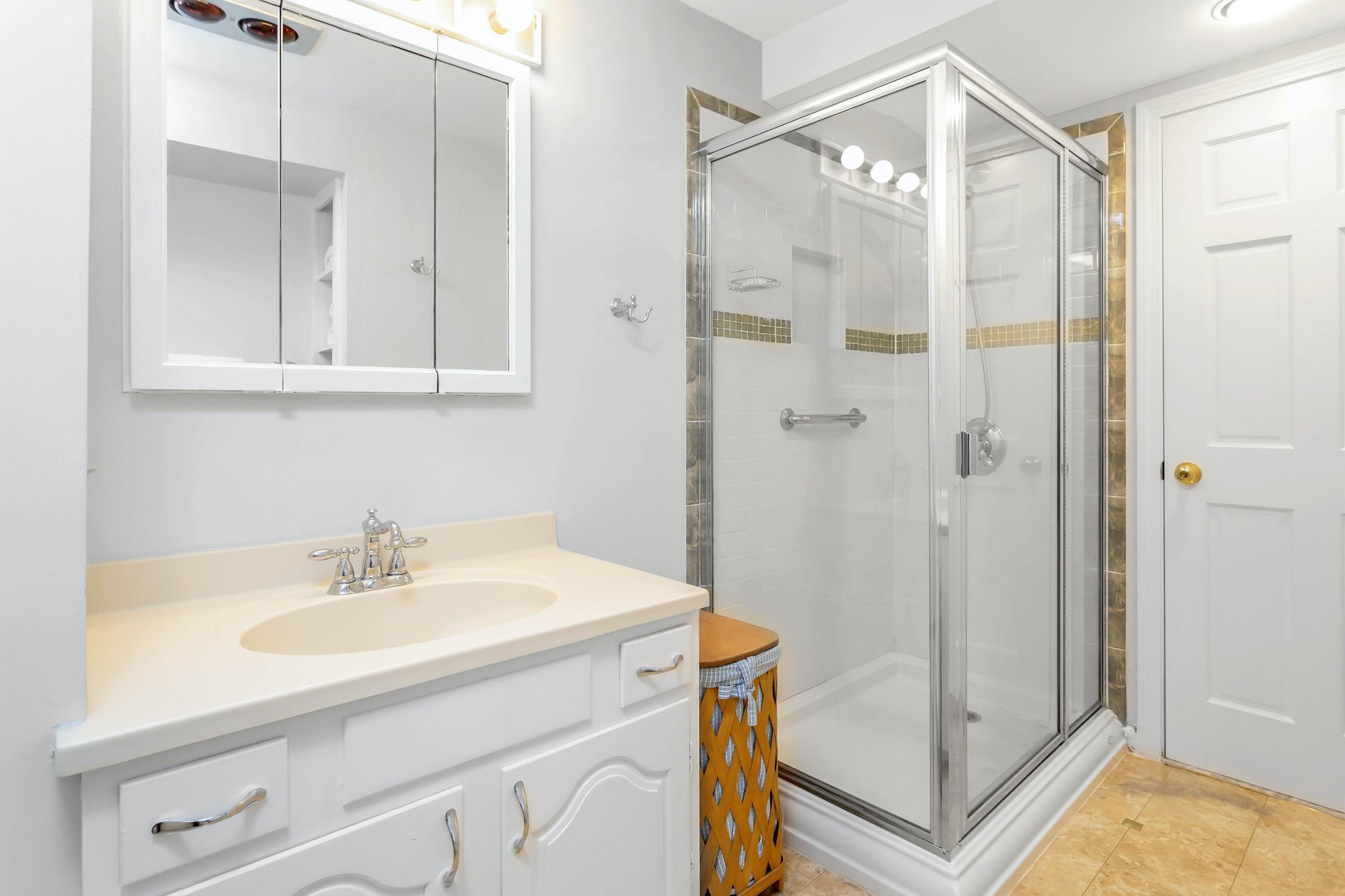 21 Revere Road Darien, CT 06820 - Photo 27 of 40 a bathroom with a sink a mirror a vanity and shower